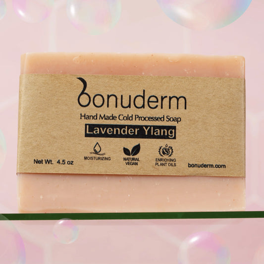 Handmade lavender soap with 'bonuderm' branding on a pink background