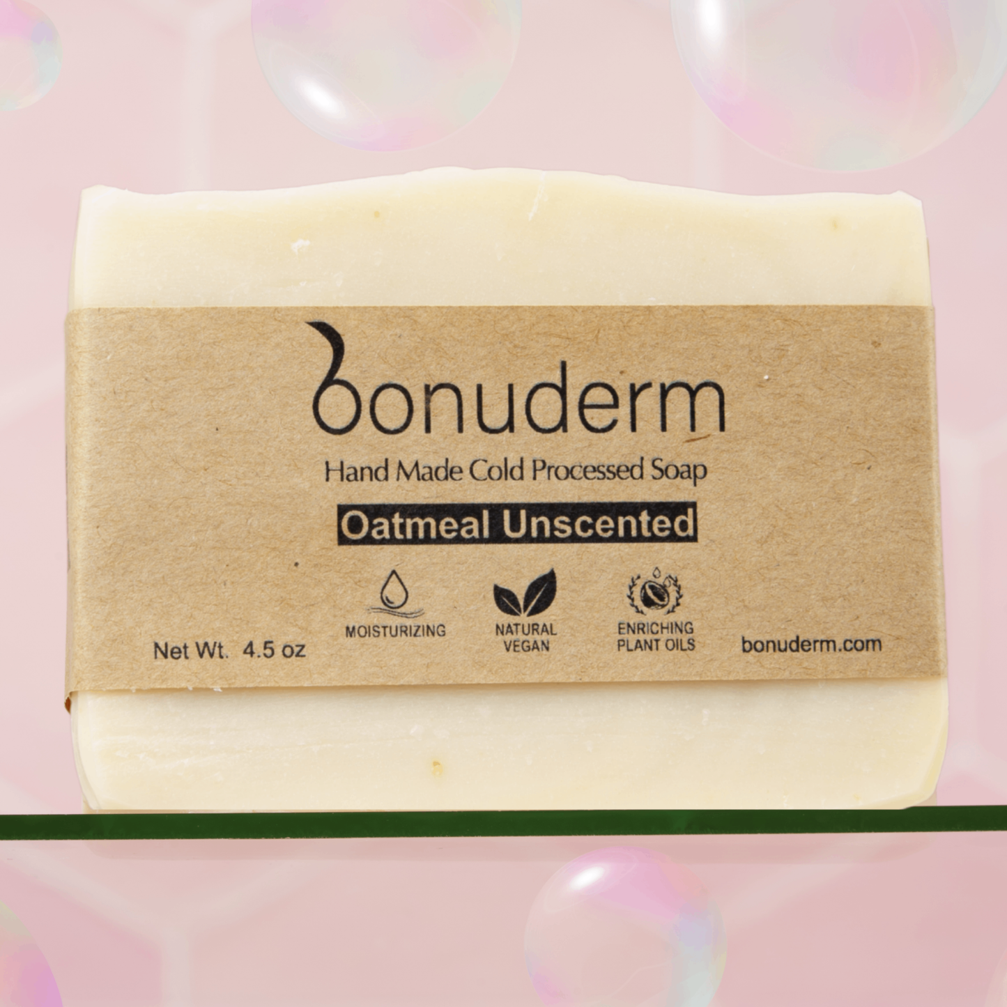 Oatmeal soap bar with a brown label on a pink background. Unscented, handmade and moisturizing.