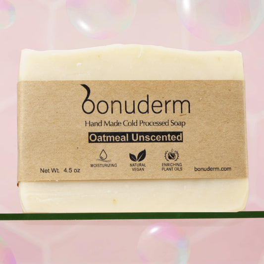 Oatmeal soap bar with a brown label on a pink background. Unscented, handmade and moisturizing.