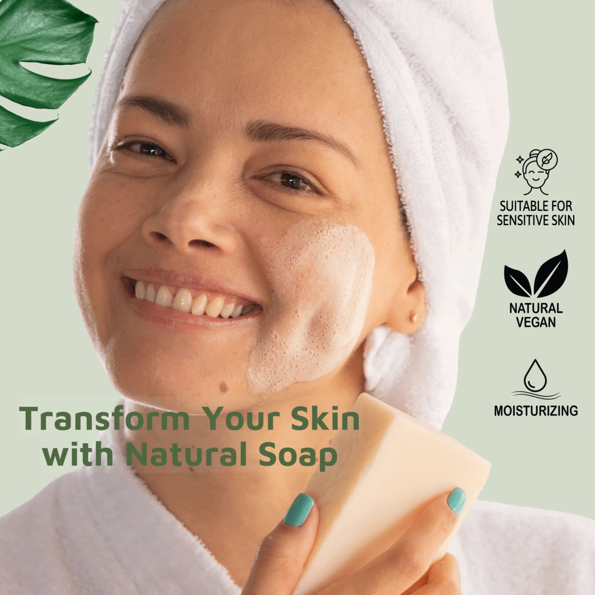 Smiling woman with a towel wrapped around her head and a bathrobe applies lather from a natural bar soap on her cheek. Icons on the side highlight that the soap is suitable for sensitive skin, natural vegan, and moisturizing.