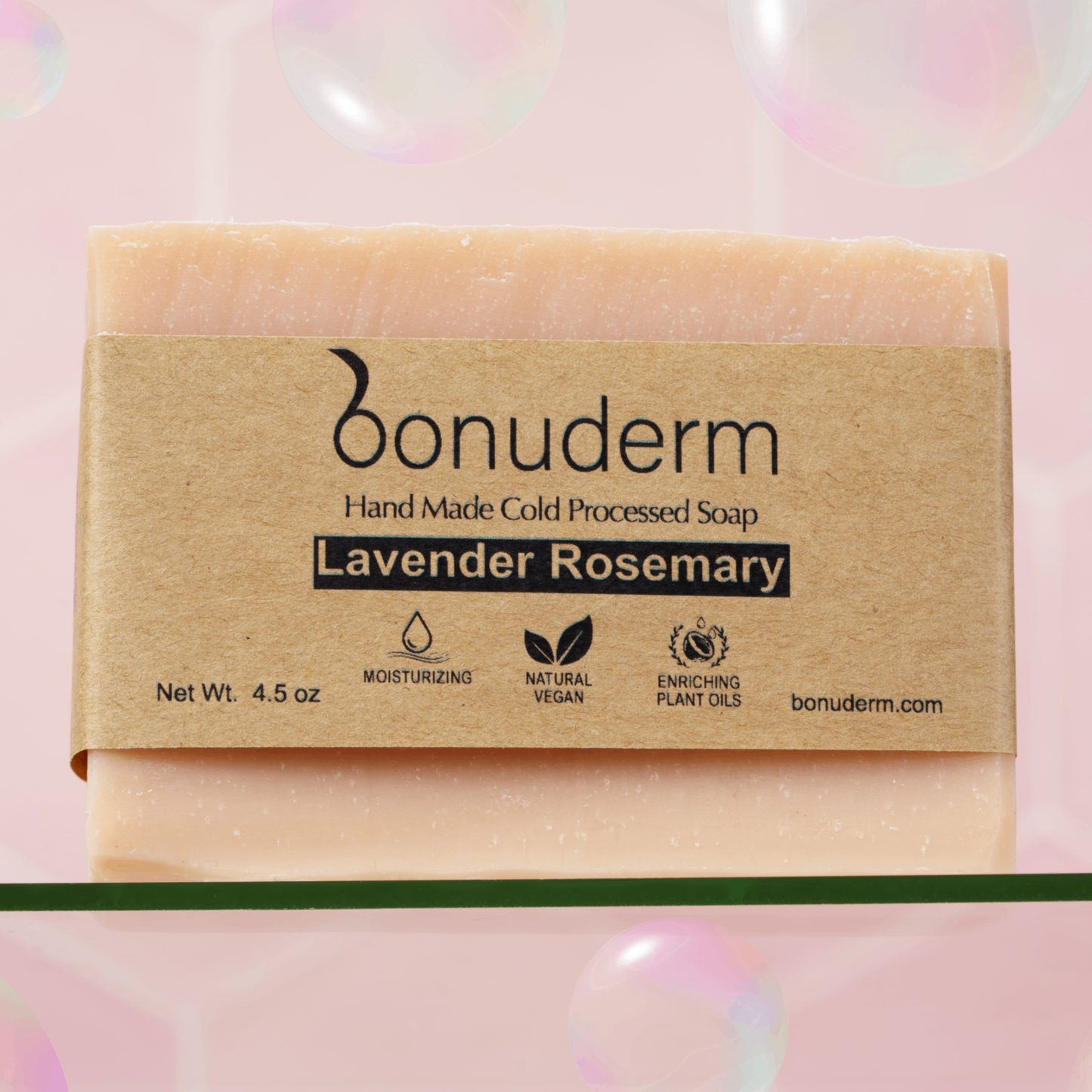 Natural Lavender Rosemary Bar of soap with 'bonuderm' packaging on a pink background