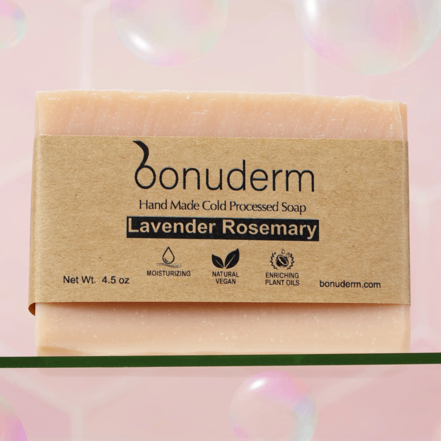 Natural Lavender Rosemary Bar of soap with 'bonuderm' packaging on a pink background