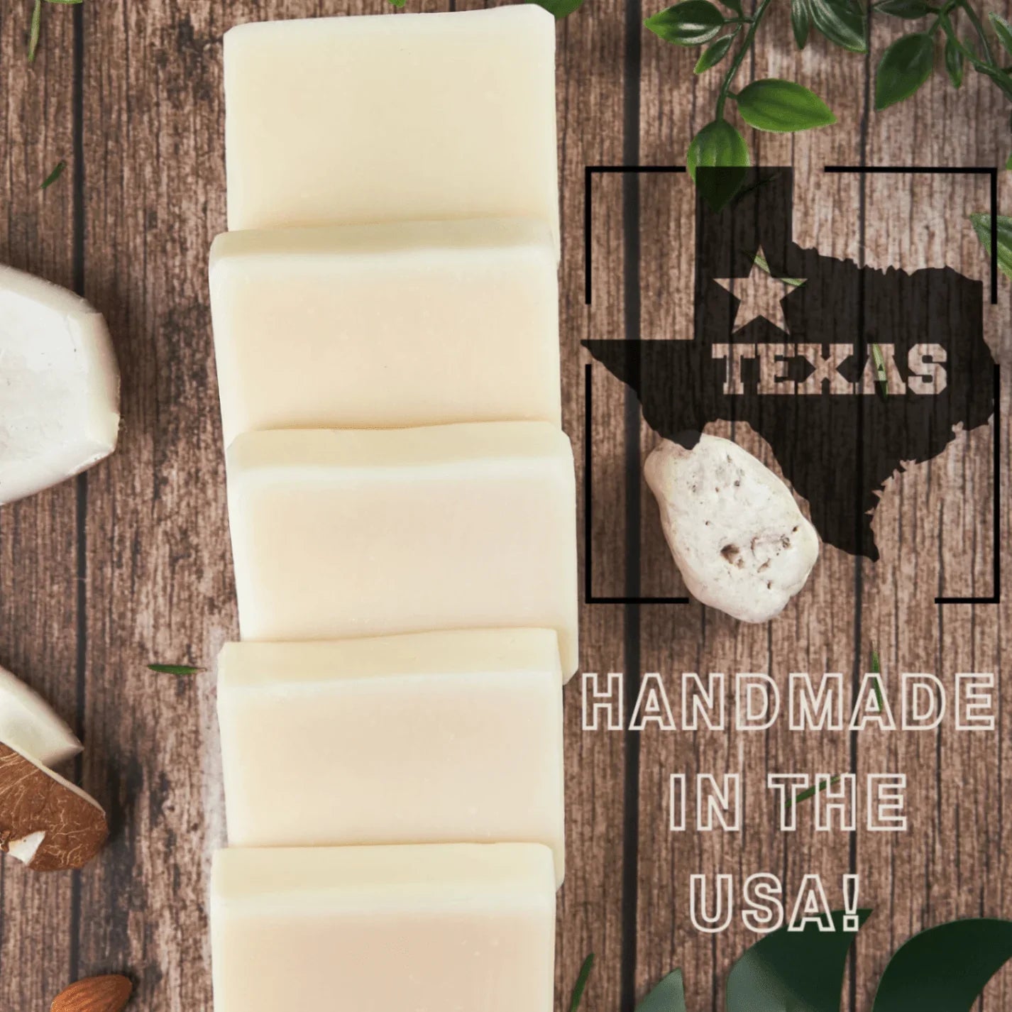 Row of Unscented soap body bars displayed on a wooden surface with coconut and almond pieces. A Texas state outline graphic and text highlight “Handmade in the USA!