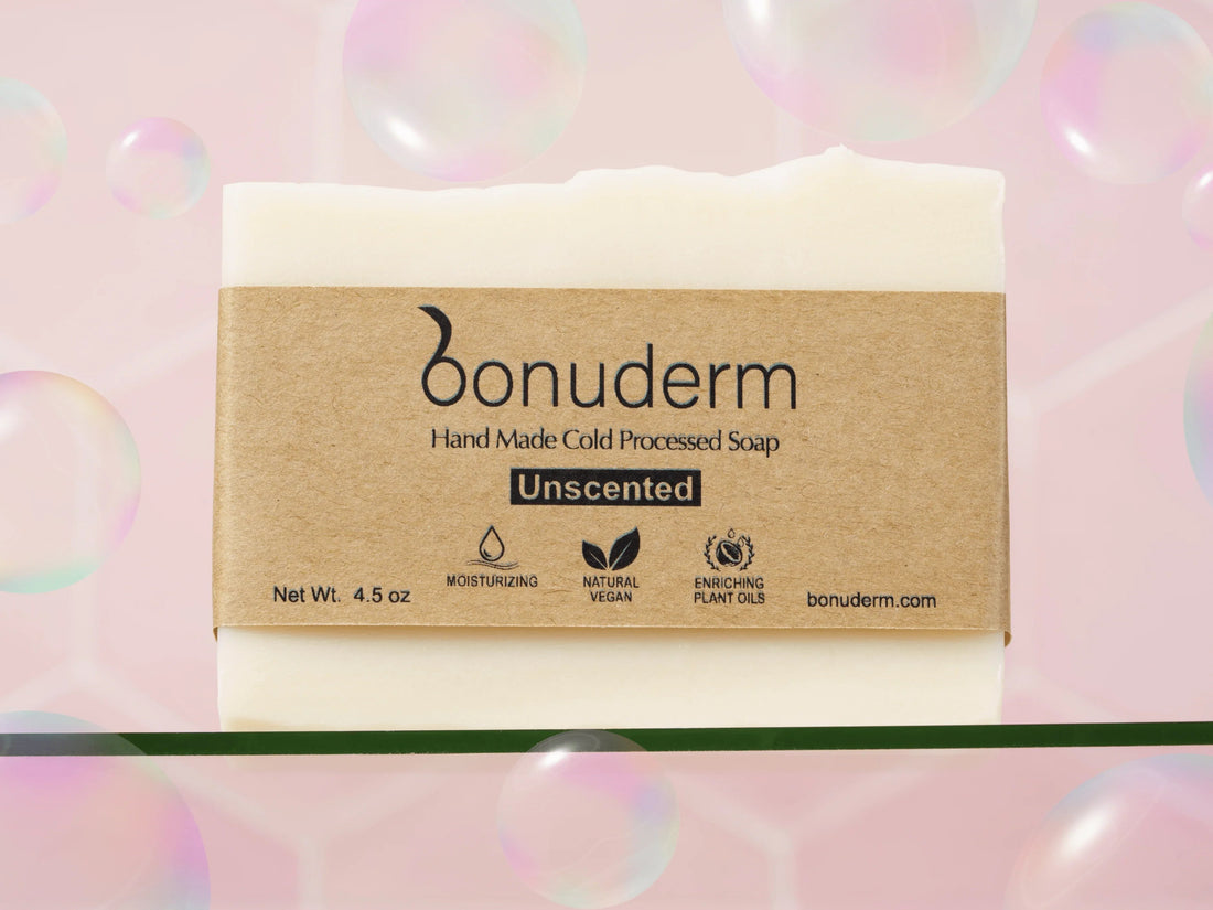 Handmade Bonuderm unscented moisturizing soap bar on soft pink background with bubbles