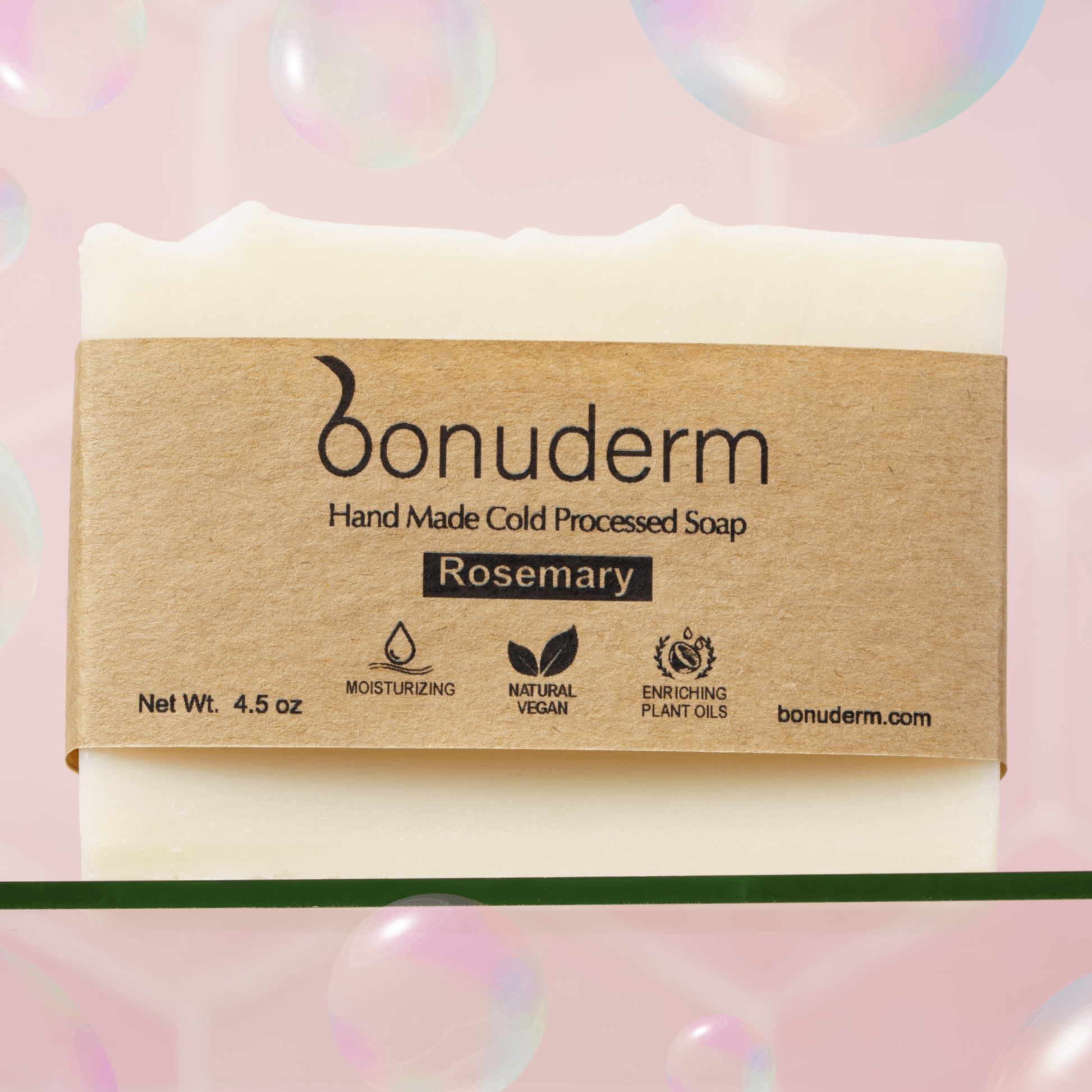 Rosemary bar soap with 'bonuderm' label on a pink background with bubbles.