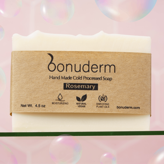 Rosemary bar soap with 'bonuderm' label on a pink background with bubbles.