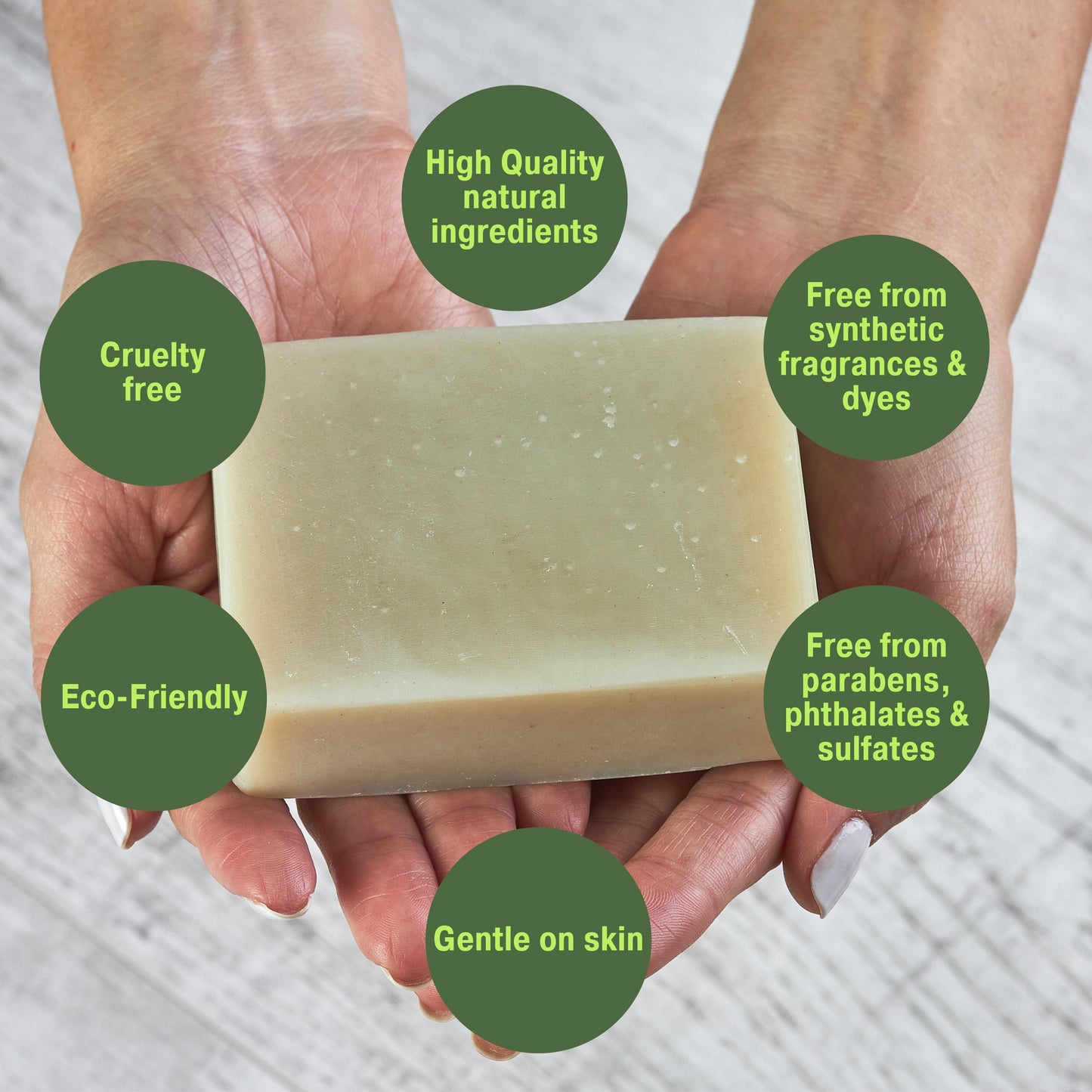 best smelling patchouli soap held between hands with green labels highlighting its benefits
