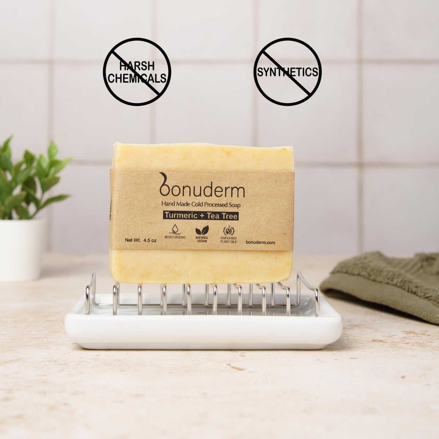 Best turmeric soap for dark spots on a soap dish with 'no harsh chemicals' and 'no synthetics' icons on a bathroom counter.