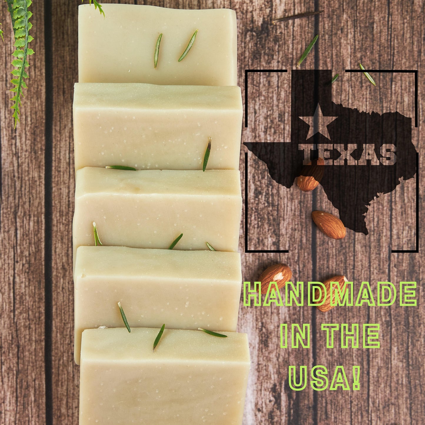 Stack of handmade best smelling patchouli soap bars with a Texas outline and almonds on a wooden background