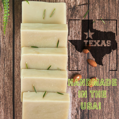 Stack of handmade best smelling patchouli soap bars with a Texas outline and almonds on a wooden background