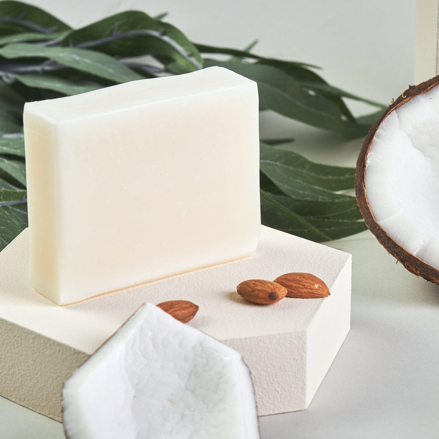 Bonuderm Unscented Bar Soap next to raw almonds and coconut pieces.