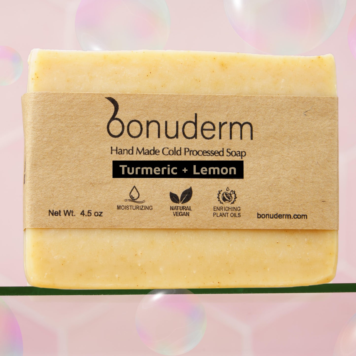 lemon turmeric soap with 'bonuderm' branding on a pink background