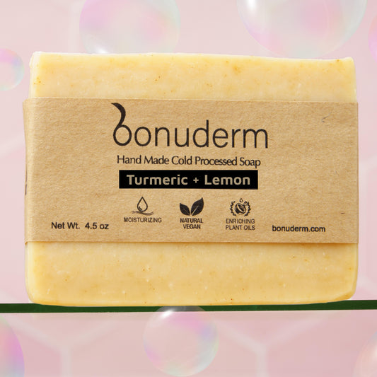 lemon turmeric soap with 'bonuderm' branding on a pink background