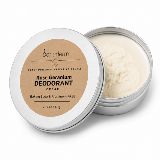 An open round silver tin of Bonuderm Rose Geranium Natural Deodorant Cream, showing the off-white cream inside, with the lid leaning against it. The lid features a kraft paper label with black text.