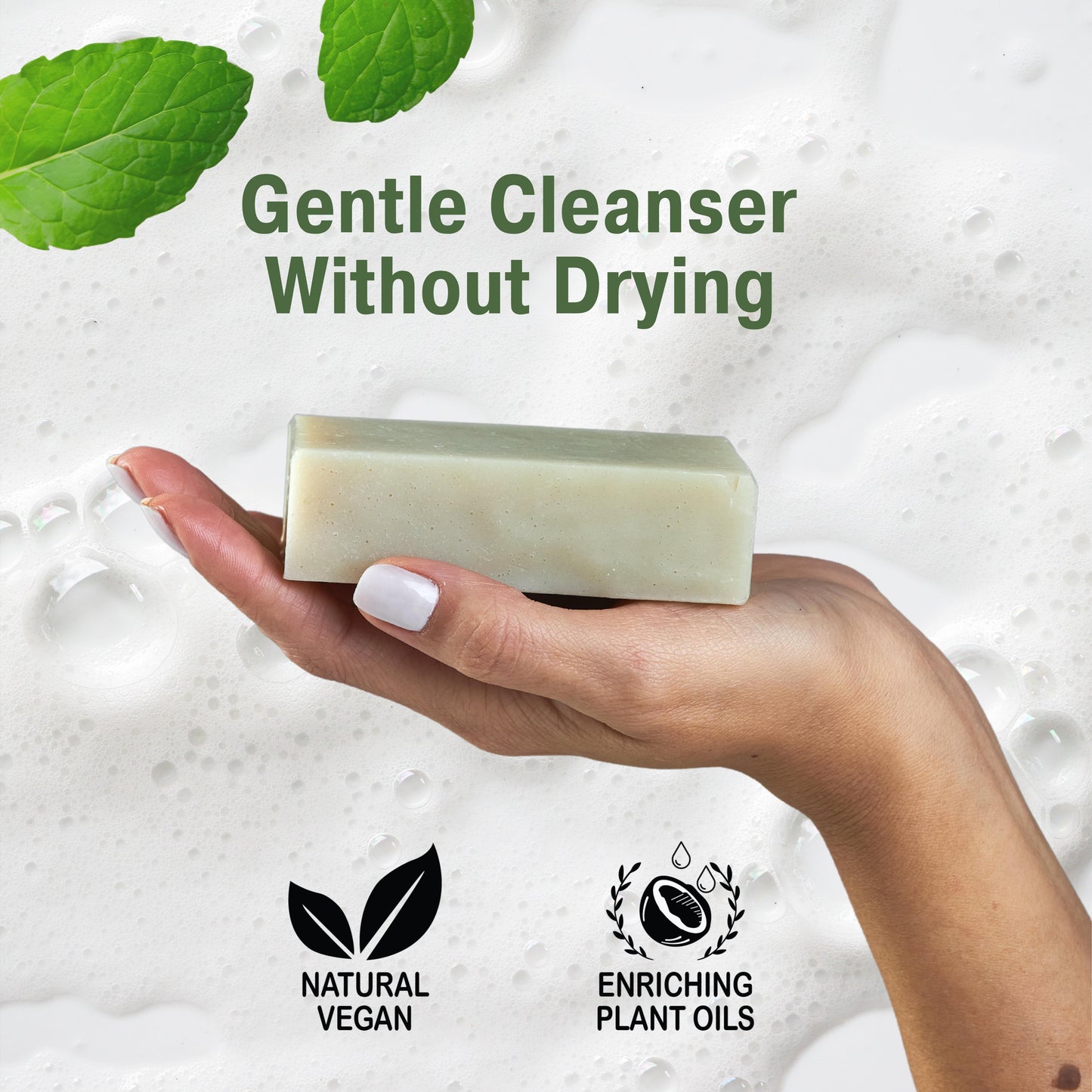 Hand holding a patchouli bar soap with green leaves and text about gentle cleanser and plant oils.