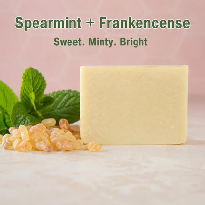 spearmint soap display next to spearmint and frankincense natural ingredients 