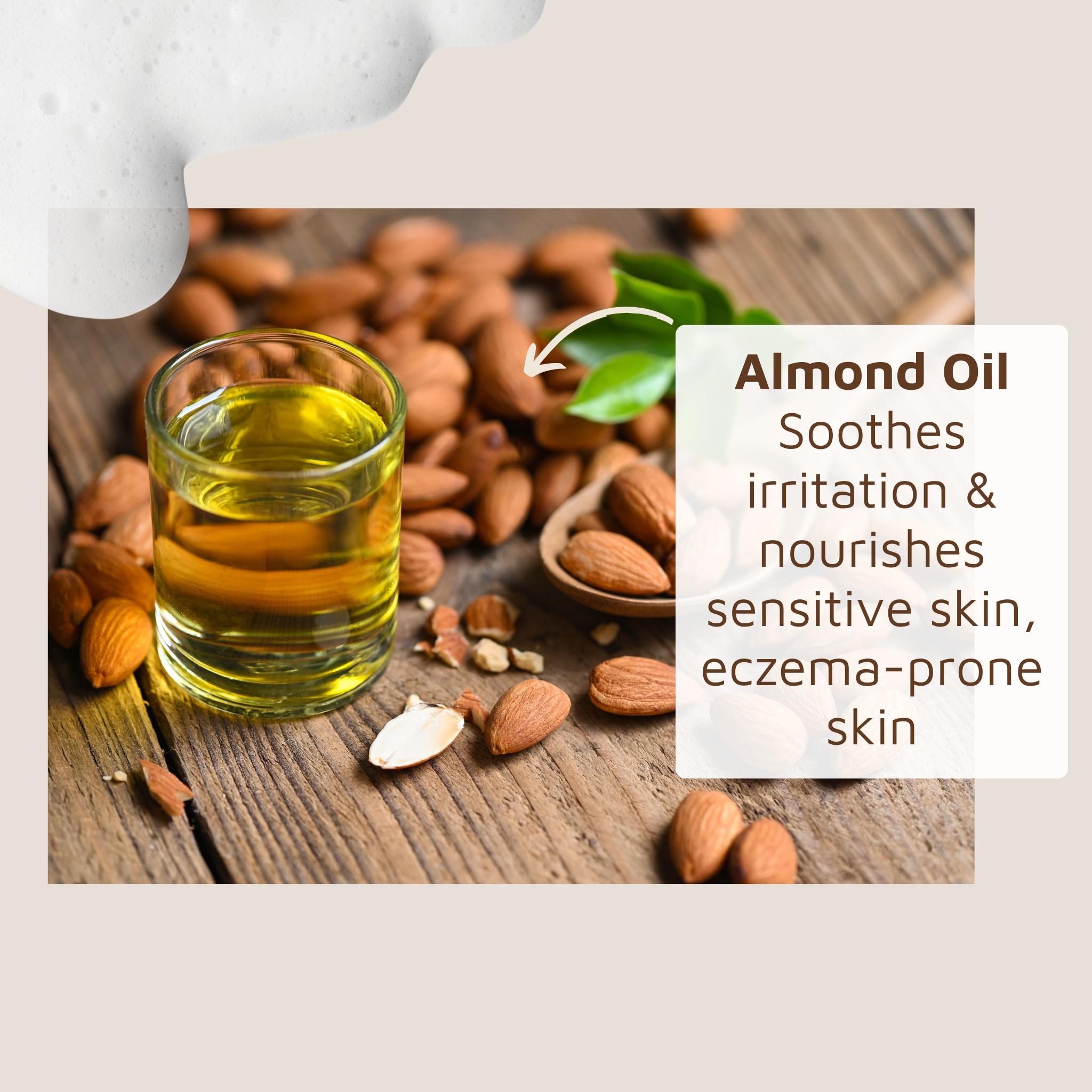 Almond oil in a glass container with almonds on a wooden surface