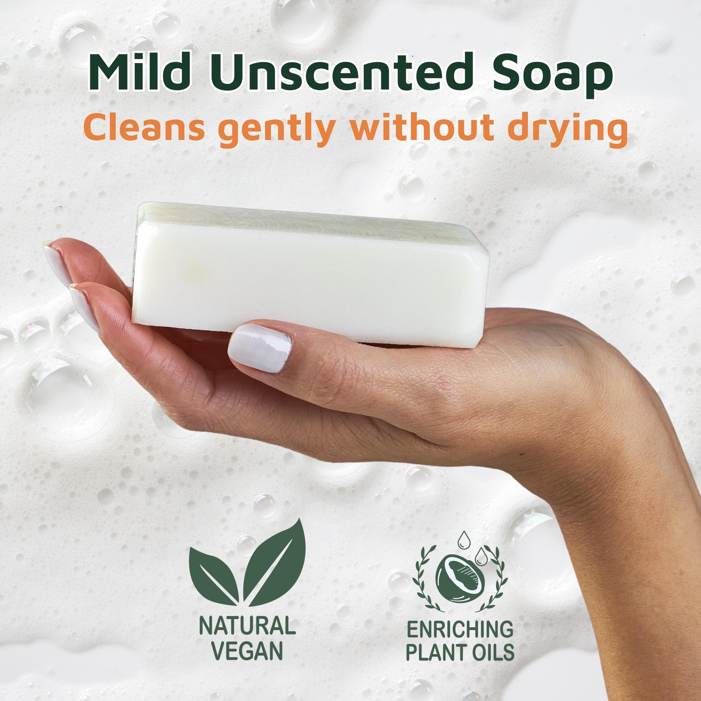 Hand holding a bar of  unscented mild soap with product benefits text and icons on a soapy background.